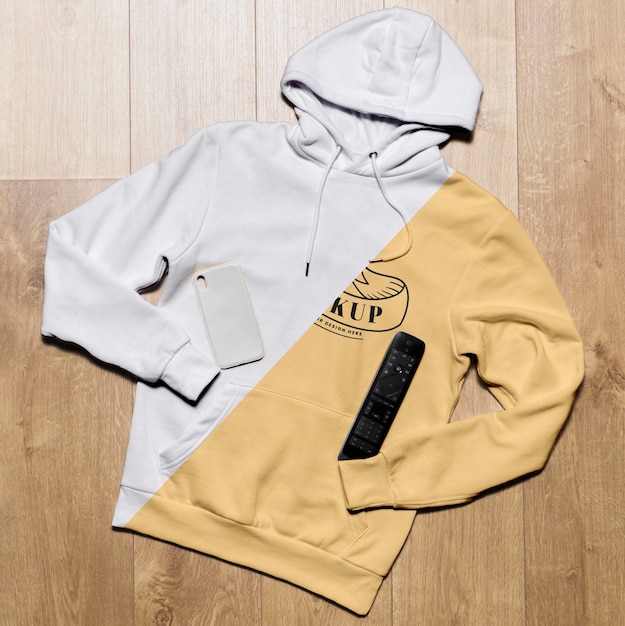 PSD top view hoodie mock-up with phone case and tv remote