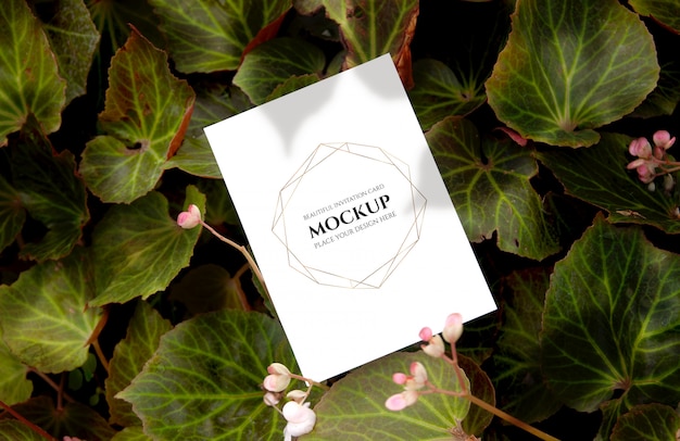 Top view of Invitation card mockup with leaves