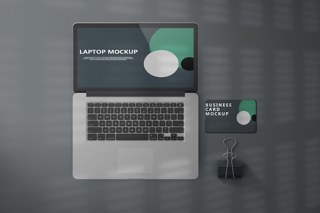 PSD top view laptop and business card mockup