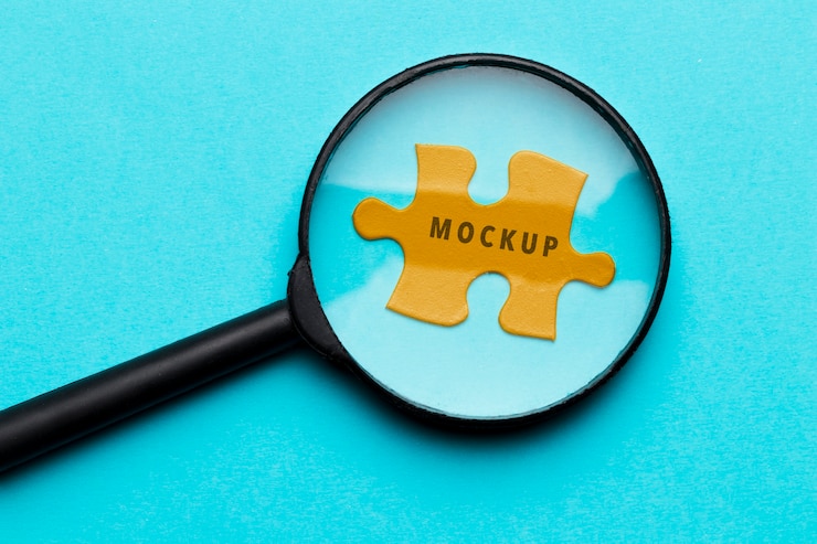 PSD top view magnifying glass on a piece of puzzle