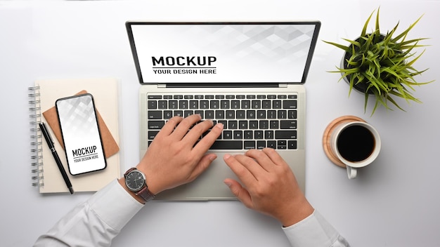 Top view of male hands typing on laptop mockup