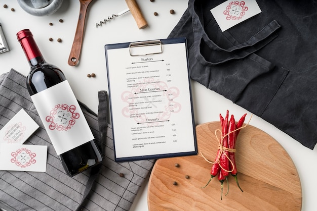 Top view of menu with wine bottle and chili peppers