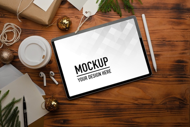 PSD top view of mockup tablet accessories and decorations on rustic table clipping path