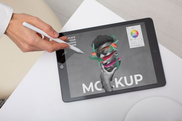 Top view model holding pencil and tablet mockup