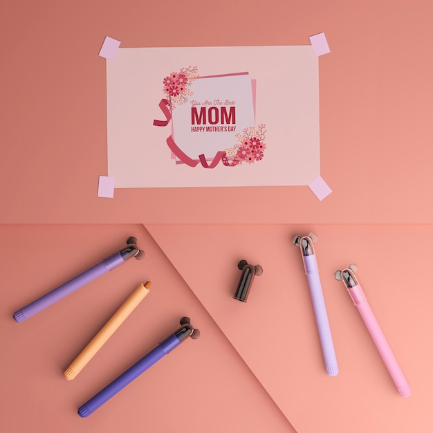 PSD top view mother's day card and markers with mock-up