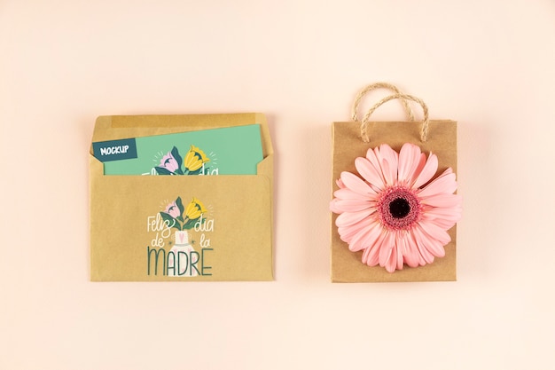 Top view of mother's day mock-up with card in envelope and bag with flower