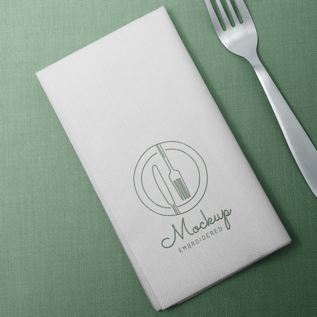 Top view napkin and fork on green background