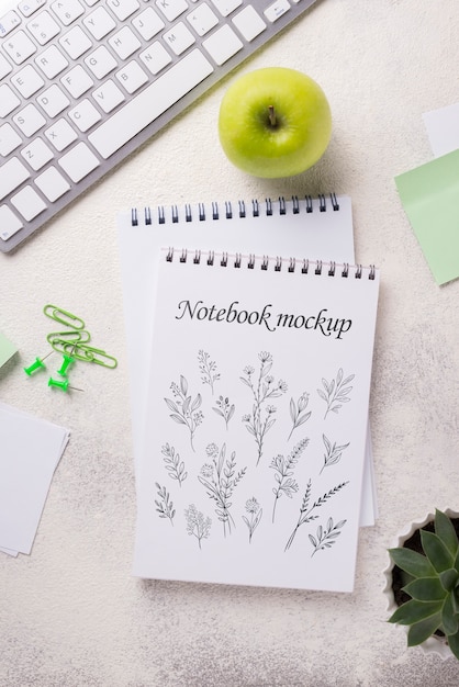 top view notebook mock-up and stationery near apple and keyboard