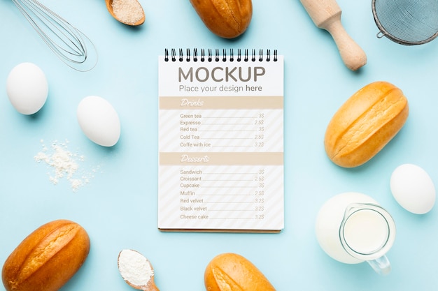 Top view of notebook with bread and rolling pin