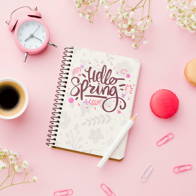 Top view of notebook with clock and coffee cup