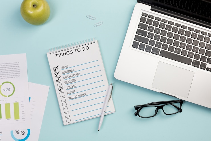 PSD top view notebook with daily tasks and laptop
