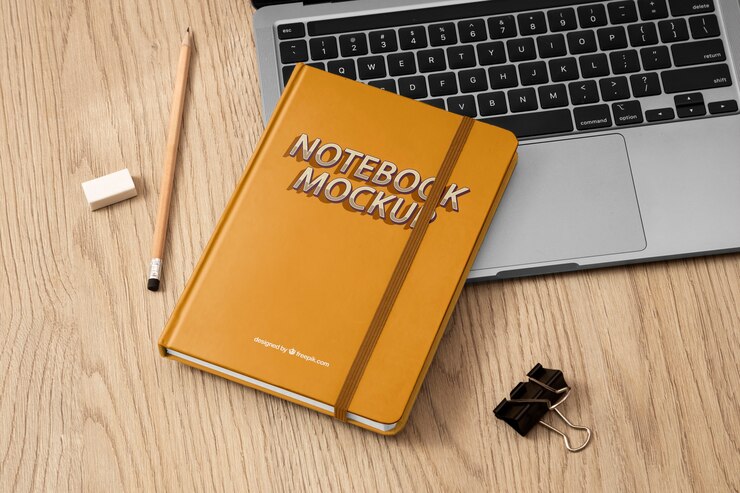 PSD top view over notebook with rubber band mockup