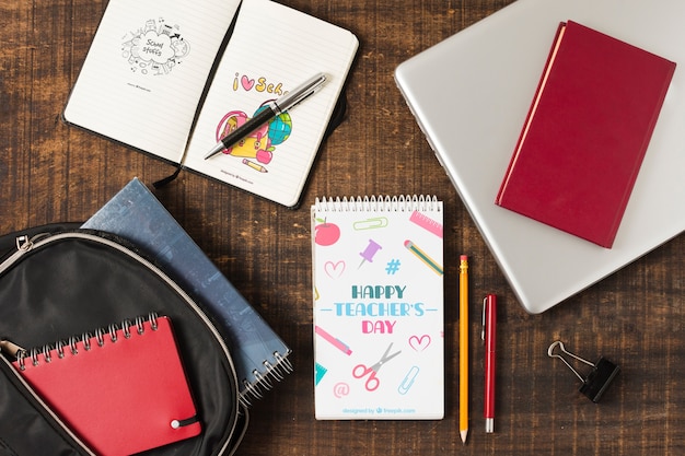 top view notebooks and laptop on wooden background