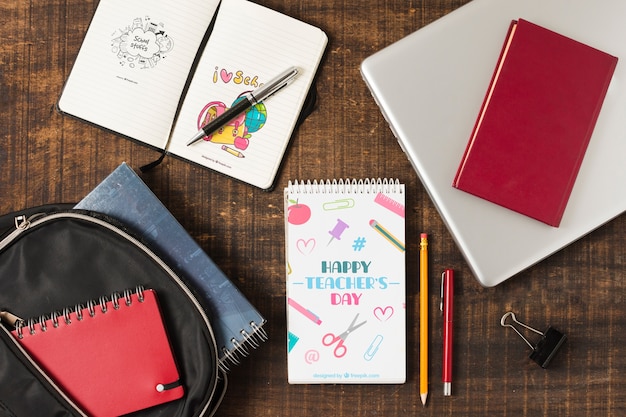 Top view notebooks and laptop on wooden background