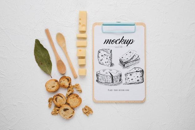 PSD top view of notepad with cheese and spoons