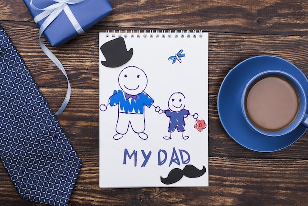 top view of notepad with tie and gift for fathers day