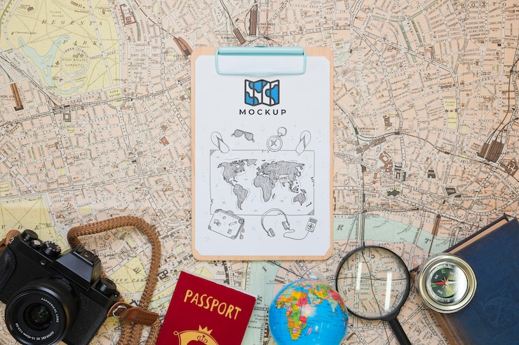 PSD top view of notepad with traveling essentials and camera