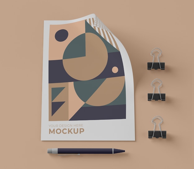 Top view of mock-up paper with pen and clips