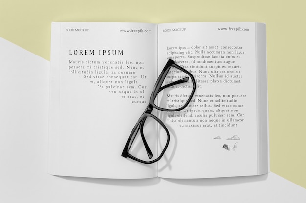 Top view open book mock-up with glasses