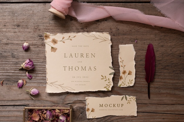 PSD top view of paper mock-up rustic wedding invitation with leaves and flowers