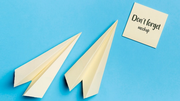 top view paper plane and sticky note with mock-up