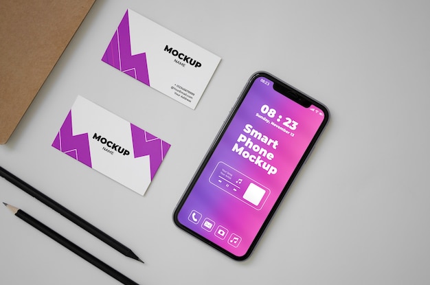 PSD top view over phone and business card mockup