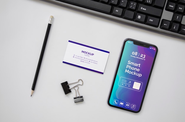 PSD top view over phone and business card mockup