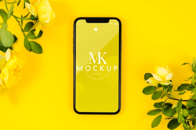 PSD top view phone mock-up with flowers