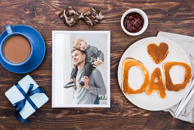 Top view of photo with coffee and gift for fathers day