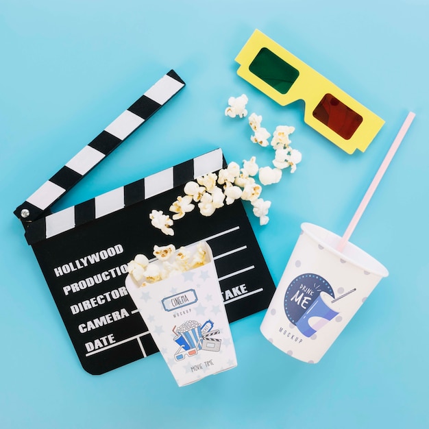 top view of popcorn cup soda and glasses for cinema