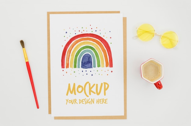 PSD top view stationery mock-up with rainbow on paper