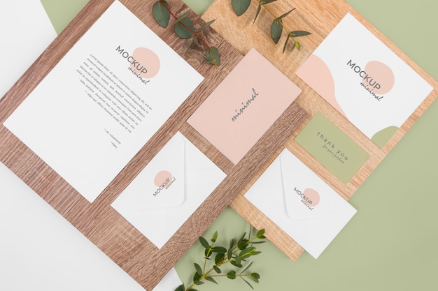 Top view stationery mockup with leaves and wood