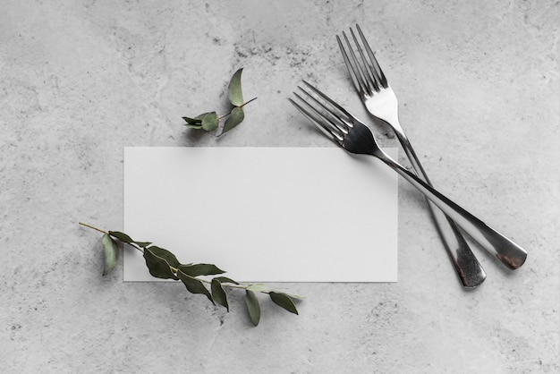 Top view of table arrangement with spring menu mock-up and forks