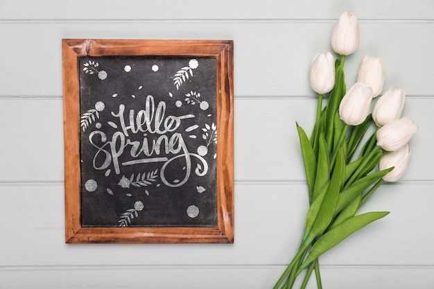 Top view of tulips bouquet with blackboard