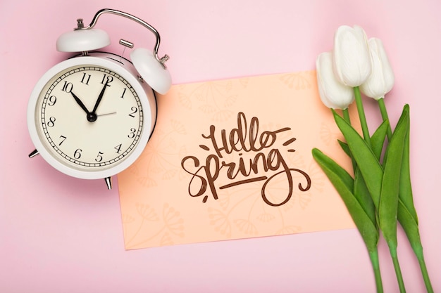 Top view of tulips with clock and card