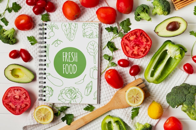 PSD top view vegetables assortment with notebook mock-up