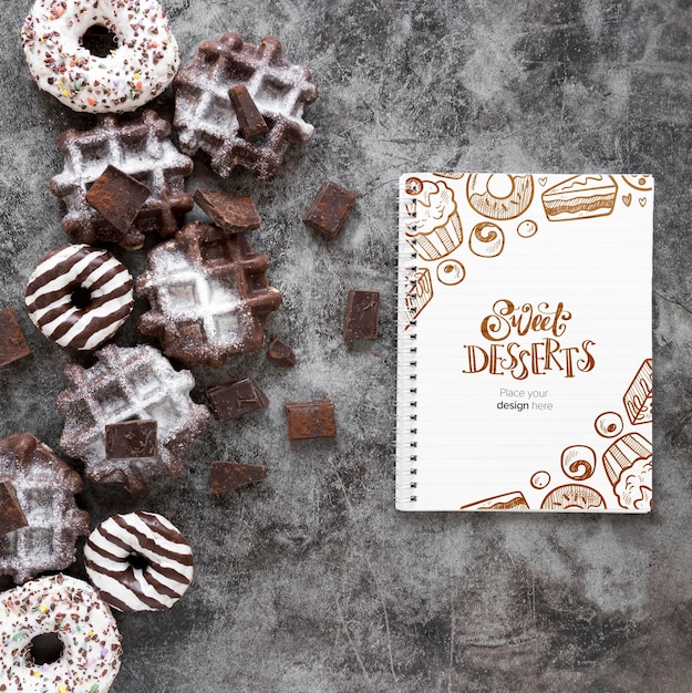 PSD top view of waffles and donuts with notebook