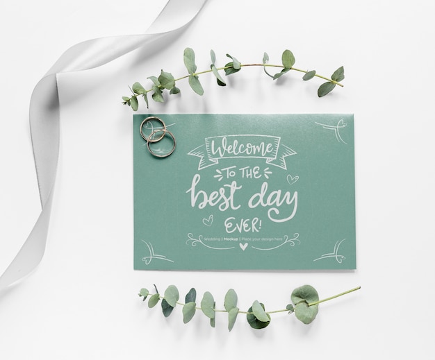 PSD top view of wedding card with plants and rings