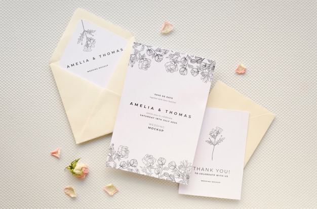 Top view of wedding card with rose and envelopes