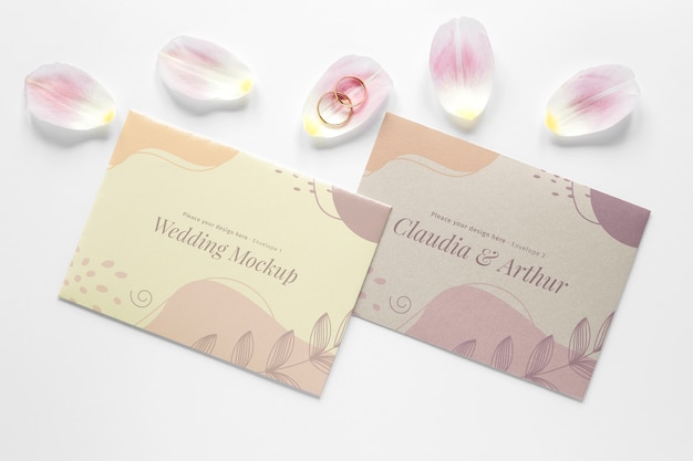 Top view of wedding cards with petals and rings