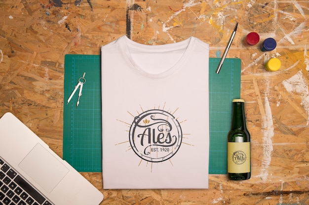 PSD top view white folded t-shirt and beer