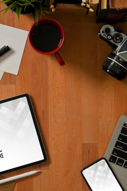 Top view of workspace with digital tablet and smartphone mockup