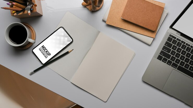 PSD top view of workspace with smartphone mockup