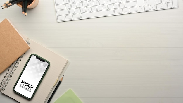 Top view of workspace with smartphone mockup