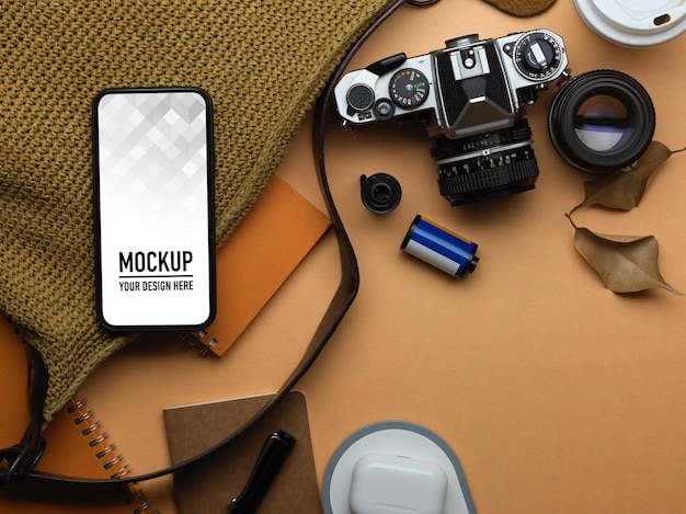 PSD top view of workspace with smartphone mockup