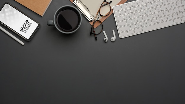 Top view of workspace with supplies and smartphone mockup