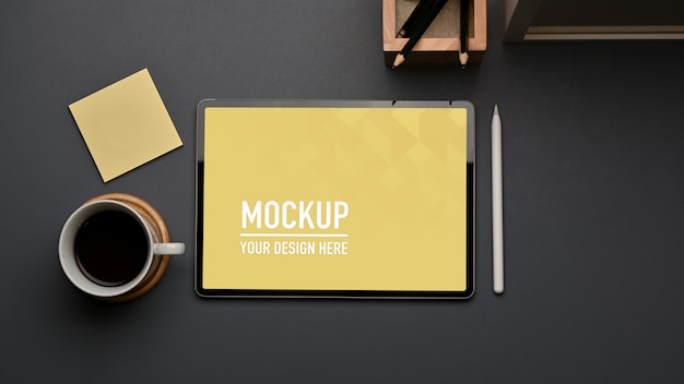 Top view of workspace with tablet mockup and stationery in home office