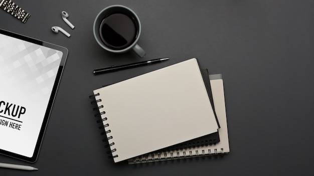 Top view of workspace with tablet mockup and supplies