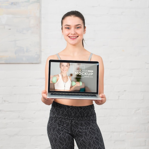 Trainer holding a laptop mock-up