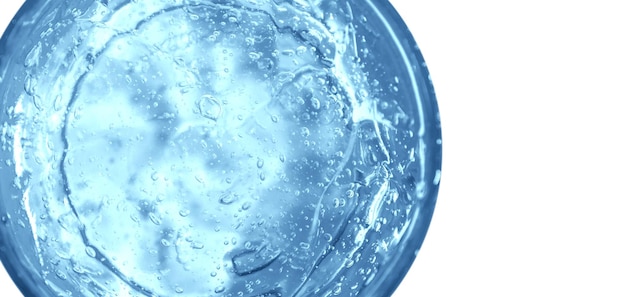 Transparent blue cosmetic gel in a round jar view from above on an empty background